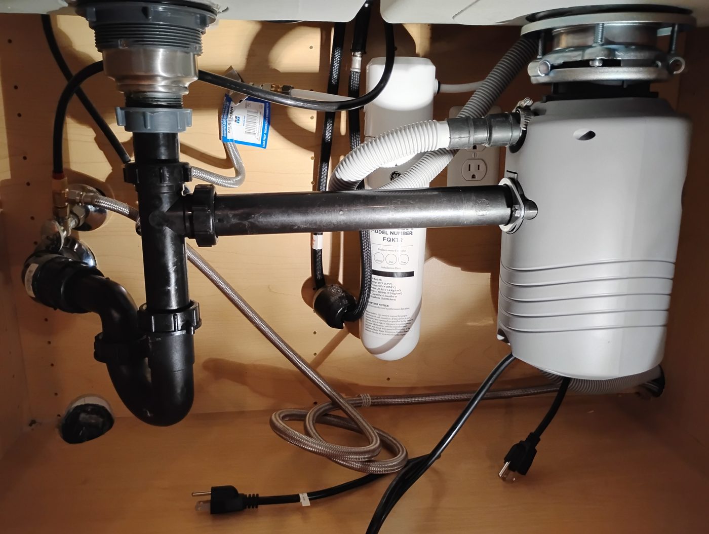 Garbage disposal and under-sink plumbing installed
