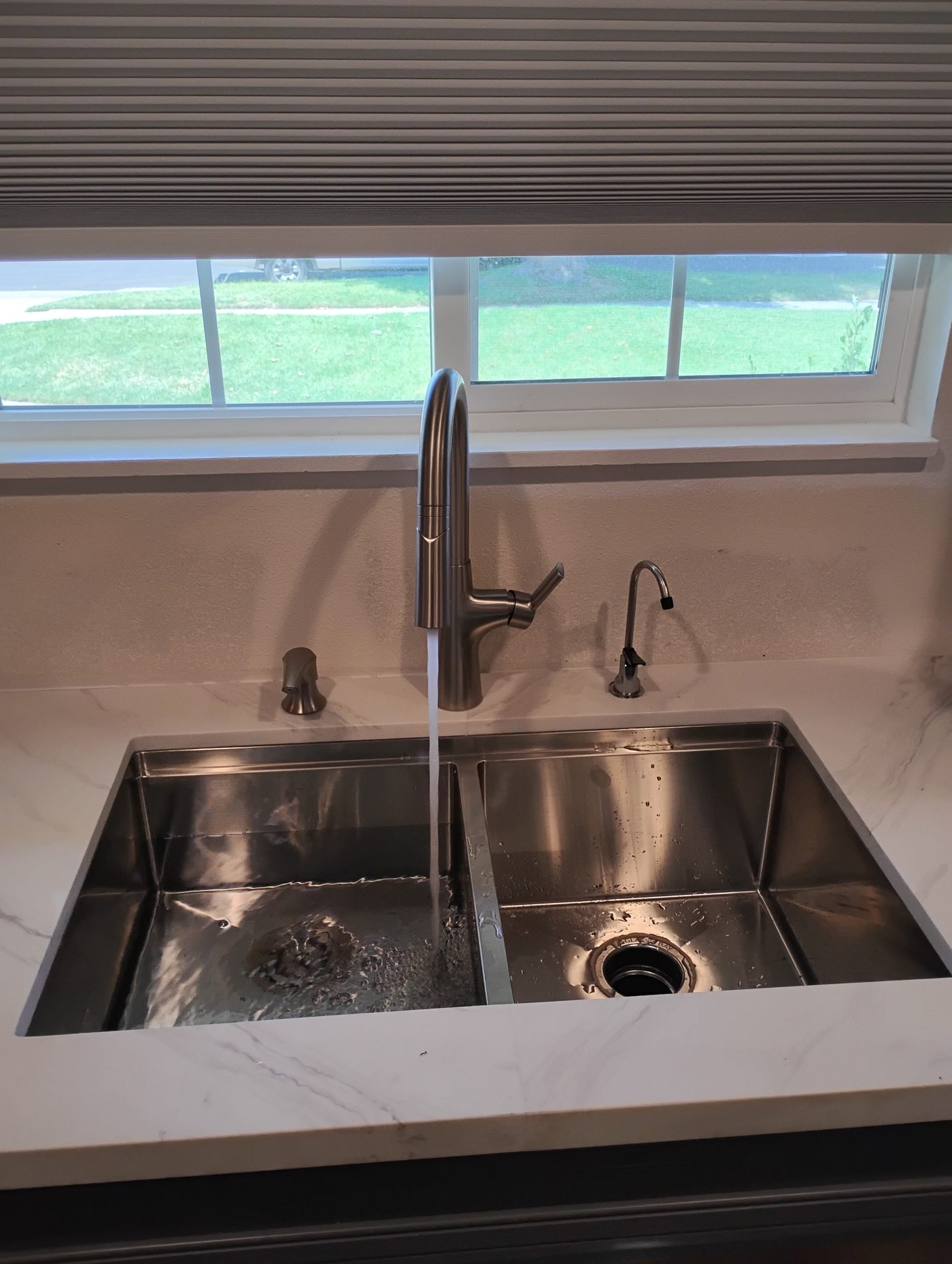 Finished stainless steel kitchen sink and faucet installed by JDP Plumbing