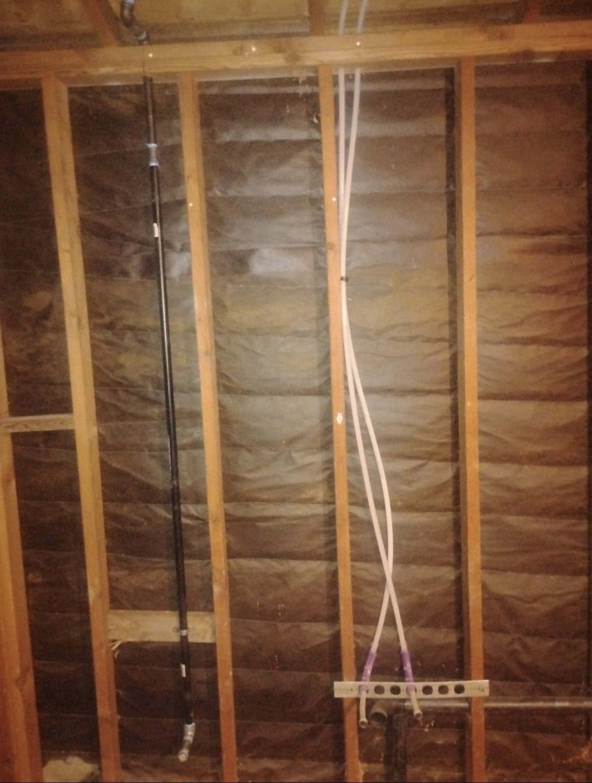 Interior wall rough-in with PEX manifold and black gas line